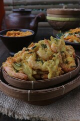 Flour fried prawns in a woven bamboo bowl