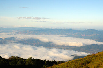 Obraz premium Landscape nature morning view with fog around mountain valley in Kew Mae Pan nature trail in Chiang mai Thailand of Doi Inthanon National Park. 3 km hiking trail. Experience rainforest, grasslands