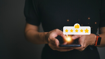 Hand pressing on smartphone screen with gold five star rating feedback icon and press level excellent rank for giving best score point to review the service , business concept