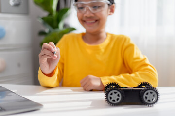 Asia students learn at home in coding robot cars and electronic board cables in STEM, STEAM, mathematics engineering science technology computer code in robotics for kids concept.