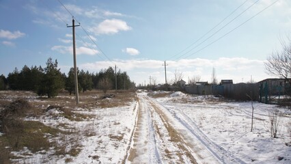 The road is covered with snow in the village