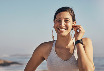 Woman, fitness and portrait while listening to music at beach for exercise, training and workout....