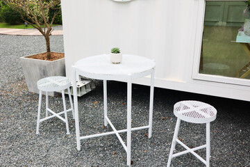 Fototapeta na wymiar White chair and table in garden,summer time.