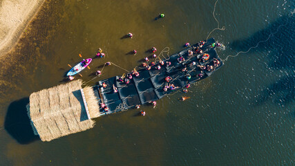 Top view People play water near a wooden raft floating on river chanaburi Thailand.