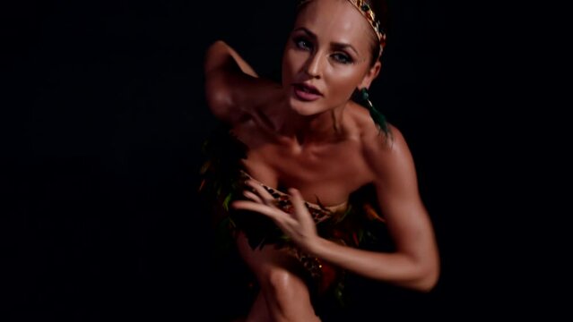 attractive woman dancing sensually in darkness, exotic wild dance of professional dancer