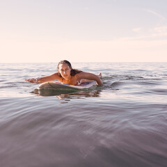 Surfing, woman and portrait in waves, sea and ocean for summer adventure, freedom and sky mockup in Australia. Female surfer, board and swimming in water, beach and relax for tropical holiday travel