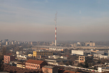 Smog lies over the skyline of Historical architecture of Belgrade city. Poor visibility, smog, caused by air pollution. Rooftop view. Emissions of plants and factories. Belgrade, Serbia 21.12.2022
