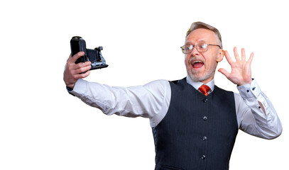 Senior man looking at camera while taking silly face selfie. Waving to the camera