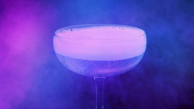 Alcoholic Drink Poured In Party Lights And Vapor