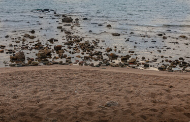 Seaside landscape. Stones on the beach and sea.