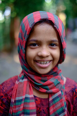 portrait of a little girl, south asian school going girl wearing colourful towel as a scarf, indian cute toddler 