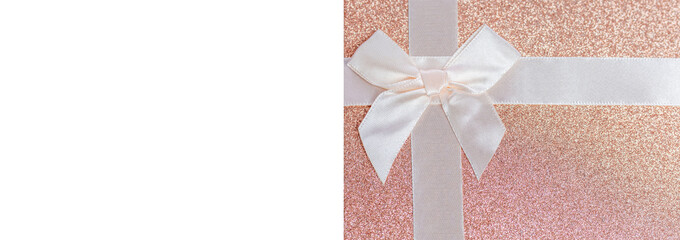 Pink mother-of-pearl holiday card with white bow. Gift box cover. Space for text. Top view.