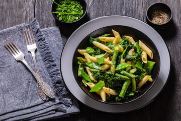 Pasta primavera with green veggies, cheese in bowl