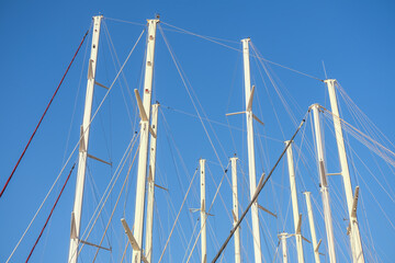 White masts against the blue sky