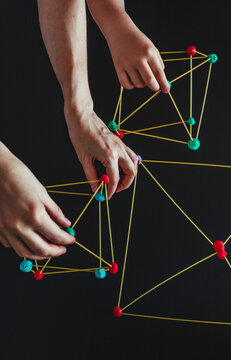 Mother and son  making geometric shapes from sticks and play dough.