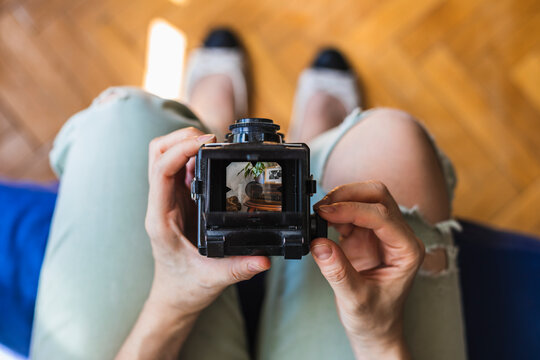 Top view of a girl takes a photo with her medium format camera.