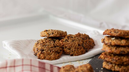 Homemade oatmeal and chocolate cookies in the shape of a heart on a wh