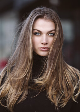 Fashion portrait of a beautiful woman with bright blue eyes