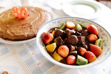 Tasty fruits and chocolate along a birthday cake for a 30th birthday
