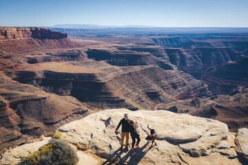 Aerial view of a family standing on a cliff of a Utah canyon