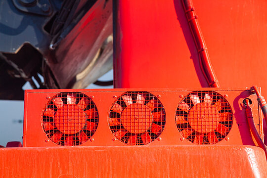 Three red industrial fans on the loading equipment.