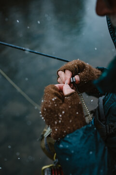 Detail photo of man changing flies while fly fishing