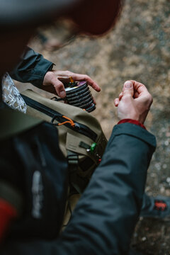 Detail photo of man pulling tippet out of holder