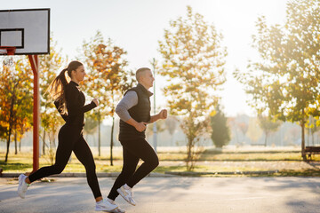 Beautiful sporty couple warming up before training