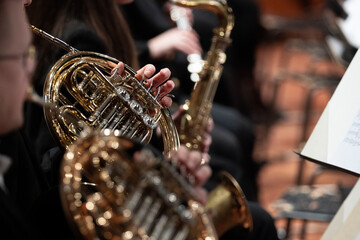 French horn players playing during a classical symphony orchestra concert