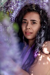 Woman wisteria lilac dress. Thoughtful happy mature woman in pur