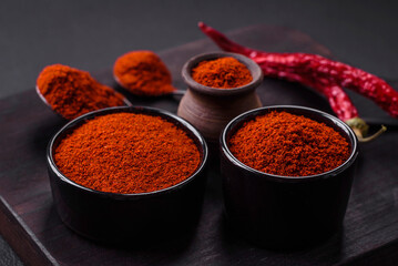 Spice smoked paprika in the form of powder in bowls and spoons
