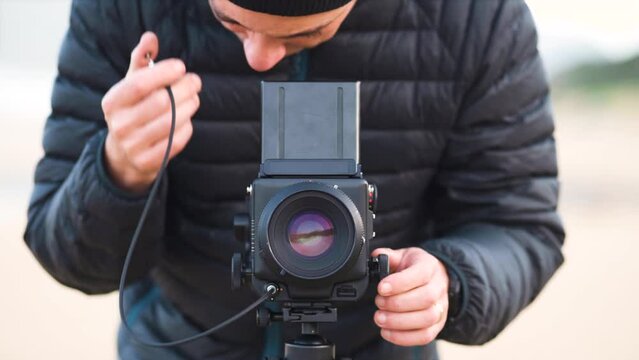 Photographer using a medium format film camera