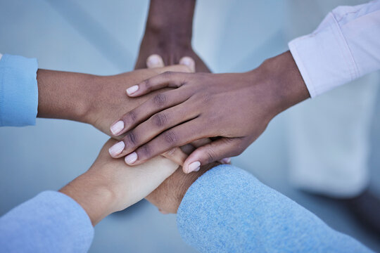 People, trust and hands together above for community, unity or team agreement in support for collaboration. Hand of group in teamwork, motivation or coordination for win or partnership in solidarity