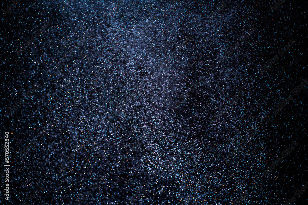 Canvas Prints organic dust particles floating on a colorful light beam on black background. glittering sparkling f