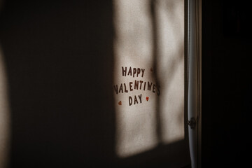 Happy Valentine's Day letters on window in morning light