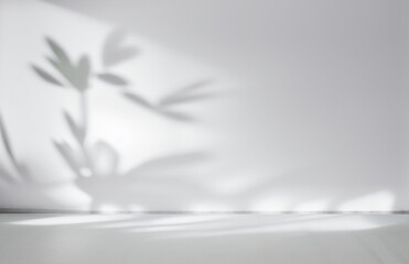 Blurred shadow from leaves plants on the white wall. Minimal abstract background for product presentation. Spring and summer. - obrazy, fototapety, plakaty