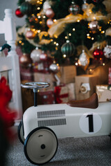 Children's toy car with Christmas tree in background.