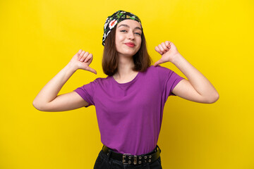 Young Ukrainian woman isolated on yellow background proud and self-satisfied