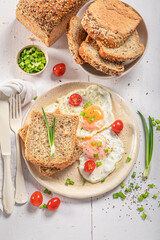 American breakfast with egg, bread and tomato.