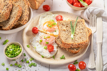 British breakfast with egg, bread and tomato.