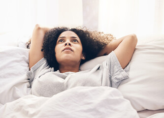 Black woman, morning and thinking in home bedroom after sleeping or resting. Peace, bed relax and...