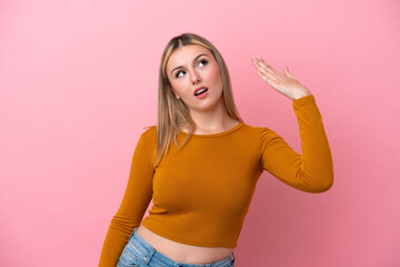 Young caucasian woman isolated on pink background with tired and sick expression