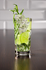 Iced soda with tarragon, lime and mint. Selective focus.