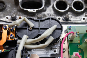 A large inductor in a plastic case and other electronic components. The process of repairing the...
