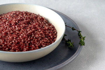 Obraz na płótnie Canvas Red wine flavored salt in a bowl. Gourmet condiment to aromatize and season food Dessert, Seafood, Meats, Pasta, Sauce, Finishing Salt