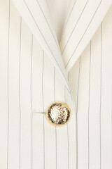white striped fabric with gold button