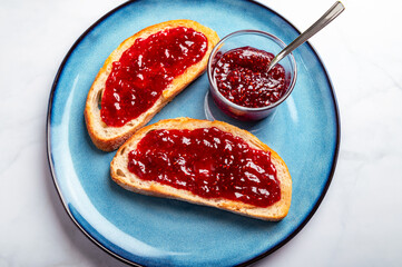 Open Sandwich with toasted sourdough white bread slices and raspberry jam