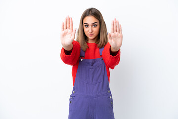 Young caucasian woman isolated on white background making stop gesture and disappointed