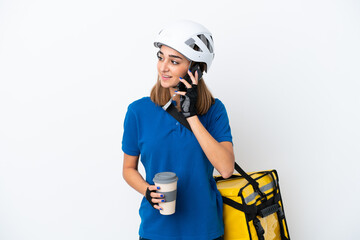 Young caucasian woman with thermal backpack isolated on white background holding coffee to take away and a mobile