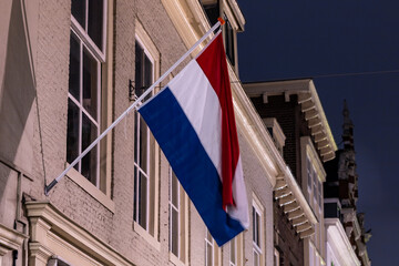 The Hague, Netherlands A Dutch flag hangs outside a hotel in the old town on molenstraat.